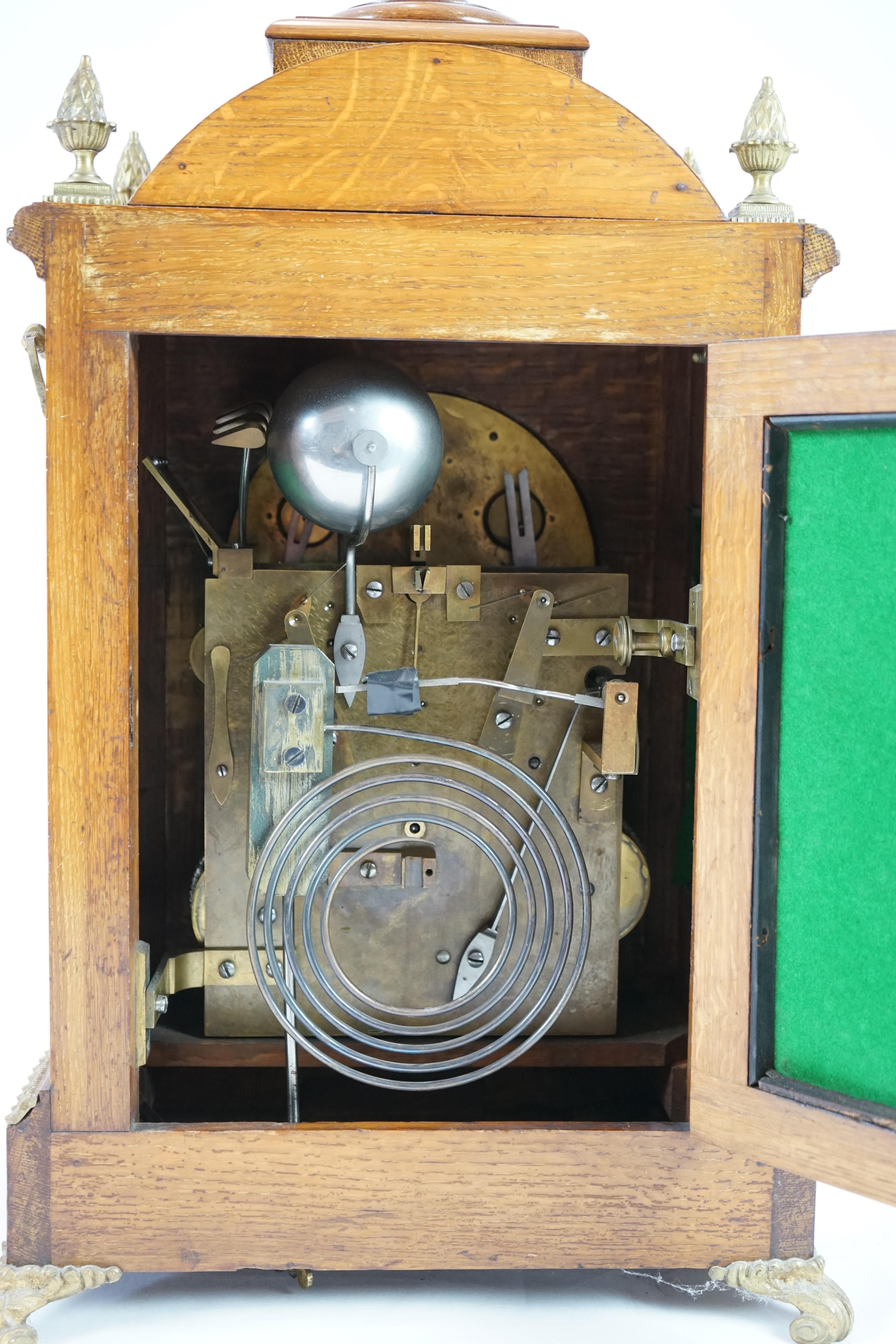 A late Victorian ormolu mounted golden oak cased eight day chiming bracket clock and bracket